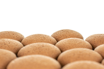 Lot of whole sweet brown chocolate sponge biscuit in closeup isolated on white background
