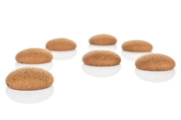 Group of seven whole sweet brown chocolate sponge biscuit isolated on white background