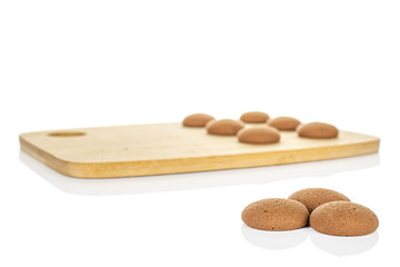 Group of nine whole sweet brown chocolate sponge biscuit on bamboo cutting board isolated on white background