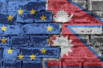 The flag of the European Union and Nepal on a brick wall