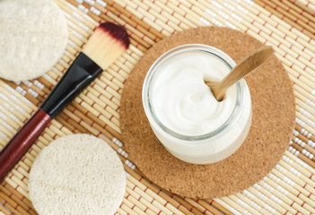 Homemade greek yogurt facial mask in the glass jar. Diy natural beauty treatment recipe. Top view, copy space.