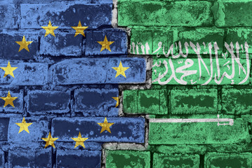 The flag of the European Union and Saudi Arabia on a brick wall