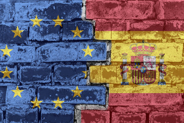 The flag of the European Union and Spain on a brick wall