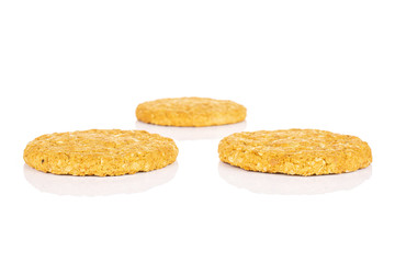 Group of three whole sweet golden oat cookie isolated on white background