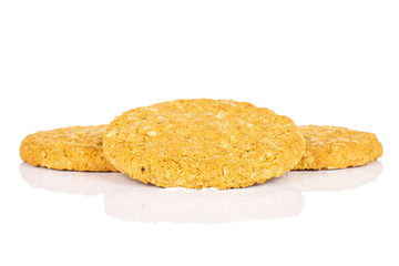 Group of three whole sweet golden oat cookie isolated on white background