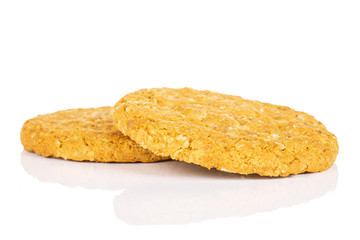 Group of two whole sweet golden oat cookie isolated on white background
