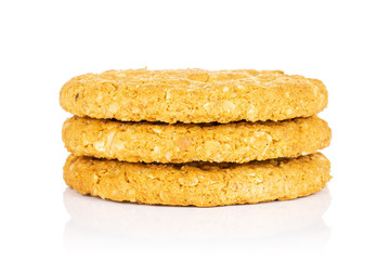Group of three whole sweet golden oat cookie in column isolated on white background