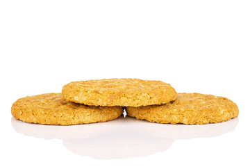 Group of three whole sweet golden oat cookie isolated on white background
