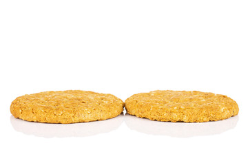 Group of two whole sweet golden oat cookie isolated on white background