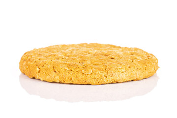 One whole sweet golden oat cookie isolated on white background