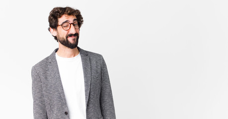 young crazy businessman looking happy and friendly, smiling and winking an eye at you with a...