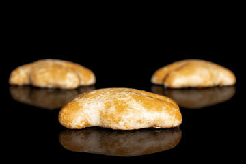 Group of three whole sweet brown gingerbread isolated on black glass