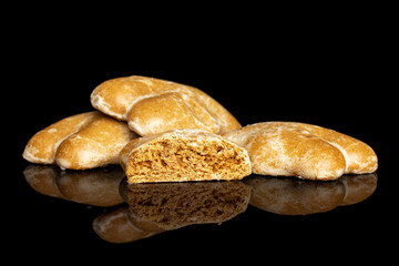 Group of three whole one half of sweet brown gingerbread isolated on black glass
