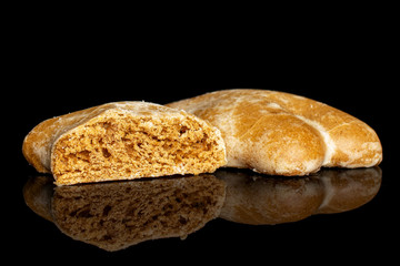 Group of one whole one half of sweet brown gingerbread isolated on black glass