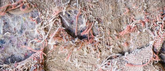 Old burlap and batting. Protruding threads. Conceptual background for design.