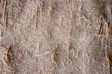 Old burlap and batting. Protruding threads. Conceptual background for design.