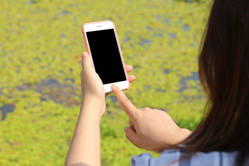 Hand woman holding mobile smart phone at park outdoor.