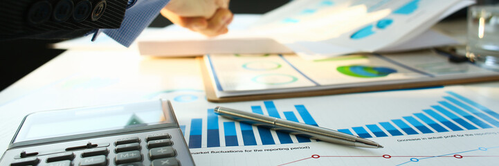 Businessman in sut hand shake in ofiice closeup. Introduce manager job man risk chart paper how...