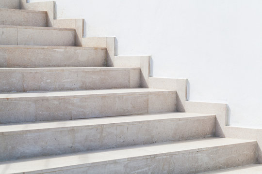 Empty stone stairway near white wall, abstract photo