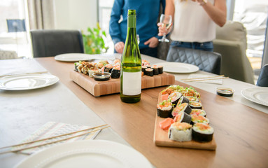 Table dinner with traditional sushi dishes and drinks