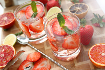 Fototapeta na wymiar Strawberry punch home made cocktail closeup on wood background