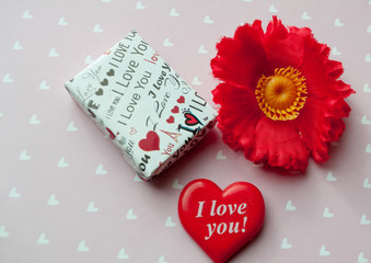 Fototapeta na wymiar cute gift box and red heart with the inscription i love you and red flower