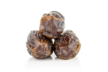 Group of three whole dry brown date fruit isolated on white background