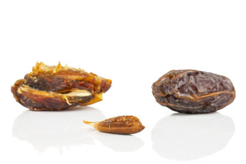 Group of one whole one half one piece of dry brown date fruit isolated on white background