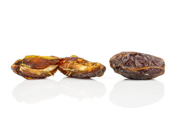 Group of two whole dry brown date fruit one is open isolated on white background