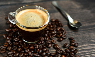 Coffee cup espresso and beans on a wooden background. breakfast concept, italian coffee