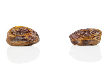 Group of two whole dry brown date fruit isolated on white background