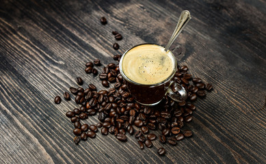 Coffee cup espresso and beans on a wooden background. breakfast concept, italian coffee