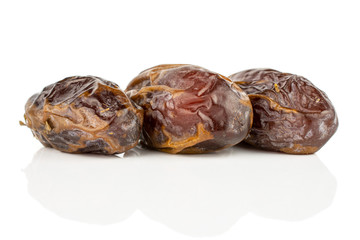 Fototapeta na wymiar Group of three whole dry brown date fruit in row isolated on white background