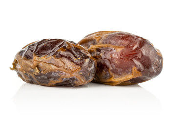 Group of two whole dry brown date fruit isolated on white background