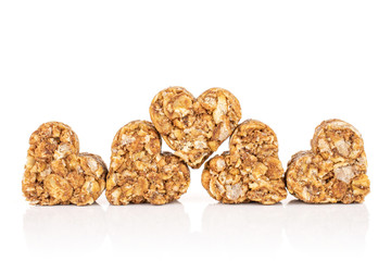 Group of five whole healthy brown cereal heart with cocoa isolated on white background