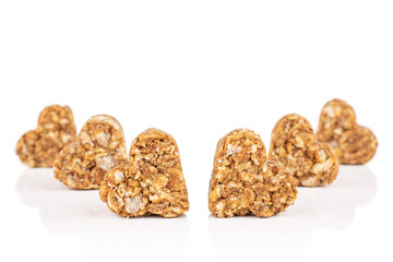 Group of six whole healthy brown cereal heart with cocoa isolated on white background