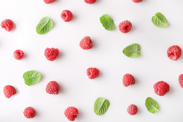 Texture of red ripe raspberries on white background