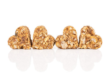 Group of four whole healthy brown cereal heart with cocoa isolated on white background