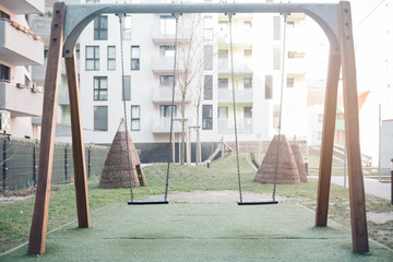 Swing set in a backyard. Childhood and youth memories concept.