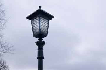 Fototapeta na wymiar black forged lantern against the sky