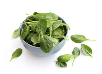 Spinach leaves in bowl isolated on white