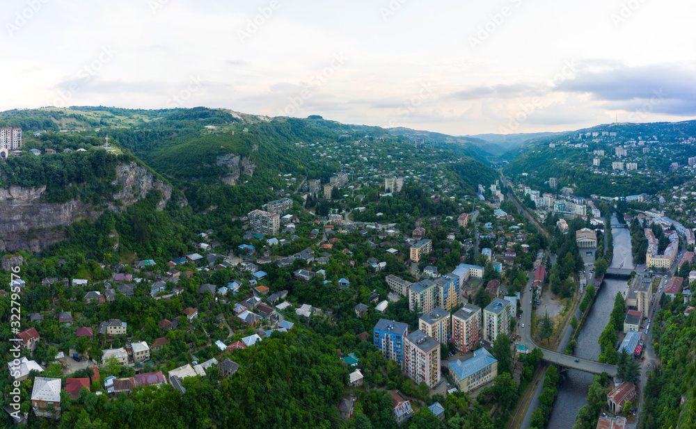 Wall mural The city of Chiatura located in the gorge of the Kvirila River, a tributary of the Rioni and on adjacent plateaus. Panorama of the city district and Upper cable car station Perevisa