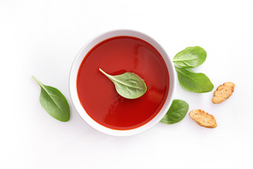 Bowl of tomato soup on white background. Top view