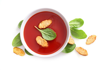 Bowl of tomato soup isolated on a white background. Top view