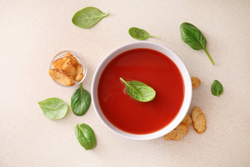 Bowl of tomato soup on kitchen table. Top view