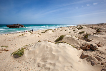 Beautiful sand dunes landscape with tourists on tour viewing a shipwreck on Boa Vista in Cape Verde