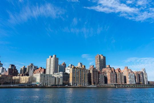 Upper East Side New York City Skyline along the East River with a Blue Sky