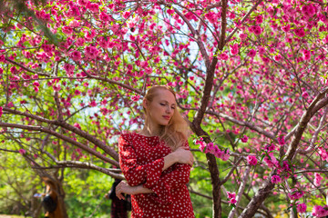 Blonde model in sakura garden 