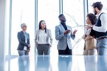 Two business teams discussing a business deal in the boardroom.