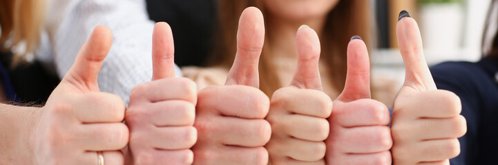 Group of people show OK or confirm with thumb up during conference closeup. High level quality...